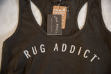 Close-up of the Rug Addict logo and brand tags on the heathered gunpowder tank.