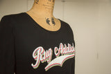 Black long sleeve t-shirt featuring multicolor retro Rug Addict screen print.
