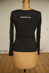 Back of the women's black long sleeve shirt with white website address print.