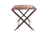 Rug Fragment Footstool featuring antique Persian Khorassan Doroksh rug and dark folding metal base.