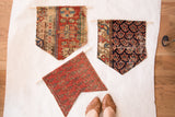 Three handcrafted Rugling cork boards displaying a variety of antique rug fragment patterns.