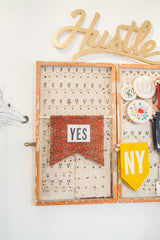 RUGLING cork board flag made from a red antique rug, styled on a vintage key holder.
