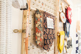 RUGLING 03: antique Northwest Persian rug fragment with dark blue field and peach stylized motifs.