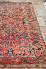 Antique Persian rug's unusual arabesque border and worn tribal Herati field.