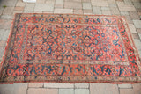 Scrolling arabesque border, an unusual motif, with tribal Herati design on this shabby antique rug.