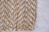 Detail of the Sadie jute rug's textured weave, showing natural brown and cream fibers.