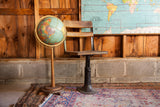 Antique wood and iron school chair with rustic charm and adjustable industrial base.