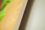 Natural wood grain texture on the thick birchwood edge of the wall art.