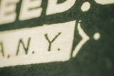 Birchwood wall art detail, showing 'N.Y.' text with visible wood grain texture.