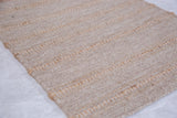 Angled detail of Shea rug's natural beige wool and jute striped texture.
