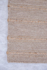 Detail of Shea rug showing natural textured wool and jute horizontal stripes.