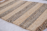Coarse handwoven jute texture with alternating natural undyed and slate gray stripes.