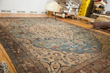 Aqua blue scalloped contour with tendrils on a distressed vintage Tabriz carpet.