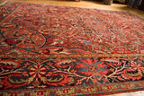 Vibrant ruby and sapphire palmette border with intricate floral field design.