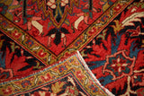 Vibrant red, blue, and gold floral border on a vintage Persian Ahar rug.