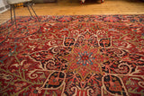 Brilliant jewel tones, scrolling leaves, and palmette motifs on a vintage Ahar rug.