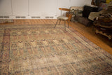 Antique Kermanshah rug, repeating Cyprus tree and milfleur patterns in reds, blues, ivory.
