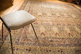 Antique Kermanshah carpet with milfleur borders, Cyprus trees, and worn ivory foundation.