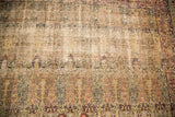 Aged Kerman rug detail, showing even wear, light foundation, and faded milfleur design.