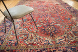 Vintage Heriz carpet with curved linear patterns in madder root red, navy, and sky blue.
