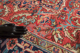 Hand-knotted vintage Heriz rug, with curvilinear patterns in madder red, blue, and gold.