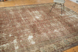 Distressed texture of a Mahal carpet, revealing Herati design in copper, sand, and light blue.