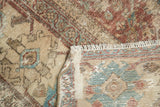 Distressed Herati pattern with copper, beige, blue tones, secured fringe, woven foundation.