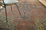Antique Farahan rug showing ivory vines on navy medallion, madder red field, and patina.