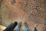 Patinated madder red floral field and navy scrolling vines on antique Farahan fragment rug.