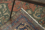 Antique Farahan rug corner showing detailed navy, red, and ivory border motifs with crisp fringe.
