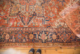 Traditional Heriz rug lower border in rich red and navy geometric motifs, with visible fringe tatter.