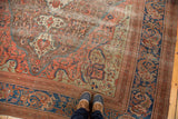 Antique Farahan carpet detail with intricate floral design in blue, oxidized copper, and green.