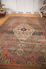 Antique Farahan carpet corner with deep blue border, blush patterns, oxidized copper field, and aged fringe.