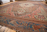 Frayed end of antique Farahan carpet, featuring unique blue and coral border motifs.