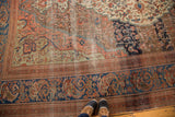 Antique Farahan rug border in deep blue with coral and time-softened hues.