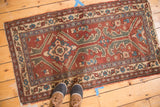 Vintage Turkish rug showing its asymmetric allover design and tattered, worn edges.