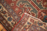 Detail of the hand-knotted construction and tattered edge of a vintage Turkish rug.