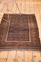 Belouch rug with geometric starbursts, ivory borders, and time-softened fringe.