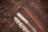 Vintage Belouch rug's woven back, brown and rust stripes, light fringe, and Ida H. Ogilvie label.