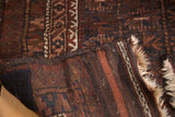 Vintage Belouch rug with geometric pile, textured kilim end, and storied fringe.