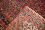 Persian Vintage Hamadan rug's hand-knotted foundation and tattered edge, showing boteh design.