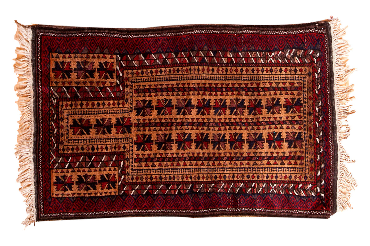Vintage Belouch rug in gold beige, cherry red, charcoal, with starburst gul and rams horn motifs.