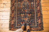 Geometric vintage Shirvan square rug with indigo, brick red, ivory colors, and worn edges.