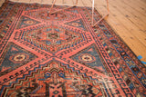 Hand-knotted vintage North West rug with geometric border in blush, sky blue, and brown.