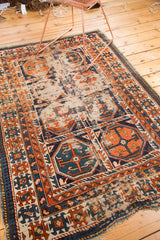 Distressed tangerine orange and sky blue gul patterns with foundation visible on this antique Caucasian rug.