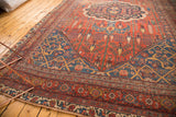 Antique Bijar carpet's brick red field, navy accents, weeping willows, and fringed edge.