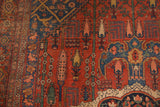Antique Bijar rug detail showing pictorial forest design, brick red field, navy blue medallion.