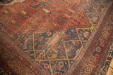Storied distress on antique Bijar rug, revealing brick red cypress and navy geometric patterns.