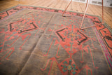 Finely woven texture of a vintage Kilim carpet with purple-gray and brick red geometric motifs.