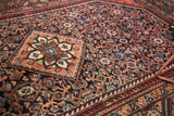 Vintage Engelas rug with classic diamond medallion and navy field, intricate Herati pattern.